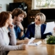 Insurance Agent Talking To A Couple About Terms Of Their Lease A
